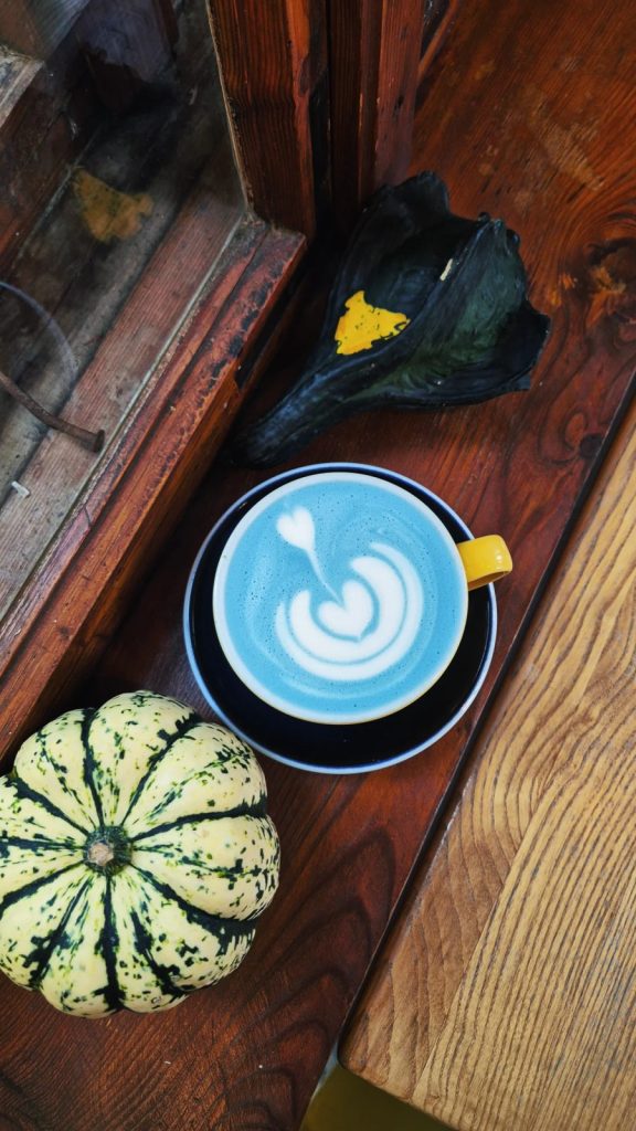 ciepły napój z latte art w filiżance w kawiarni Colbergcoffee jesienią